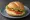 Käse-Tomaten Brötchen: an illustration of cheese, tomato, butter and lettuce on kaiser roll.