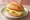 Käsebrötchen: an illustration of cheese, butter, lettuce and tomato on kaiser roll.