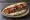 Kebab Arni: an illustration of lamb, onion, tomato and tzatziki.