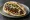 Kebab Bakar (קבב בקר): an illustration of beef, onion, parsley and tahini on pita.
