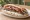 Kebab Hirino: an illustration of pork, onion, tomato and tzatziki.