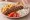 Kebab Merida: an illustration of pork, onion, tomato, tzatziki and more on pita.
