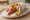 Kebab se Pita: an illustration of pork, onion, tomato and tzatziki on pita.