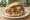 Kebab w Bułce: an illustration of beef, cabbage, onion, tomato and more.