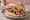 Kebab z Kurczaka: an illustration of chicken, cabbage, onion, tomato and more.