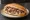 Kelle Paça Sandviç: an illustration of lamb, garlic, vinegar and lemon on bread.