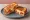 Kimchi Grilled Cheese: an illustration of cheese, kimchi and butter on white bread.