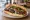 Köfte Ekmek: an illustration of beef, lamb, onion, parsley and more on bread.