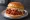 Korean Fried Chicken Sandwich (KFC 샌드위치): an illustration of chicken, gochujang, garlic, maggi seasoning sauce and more on burger bun.