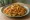 Kothu Parotta: an illustration of egg, onion, tomato and pepper.