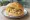 Krabben mit Rührei: an illustration of shrimp, egg and butter on kaiser roll.