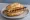 Kulmbacher Bratwurst: an illustration of sausage, pork and mustard on kaiser roll.