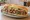Kuzu Döner: an illustration of lamb, onion, tomato, lettuce and more on bread.
