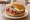 Labskaus Brötchen: an illustration of beef, potato, egg, herring and more on kaiser roll.