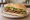 Lomito Común: an illustration of beef, lettuce and tomato on baguette.