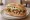 Lonche: an illustration of pork, onion, tomato and avocado.