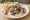 Makanek b'Laban (مقانق باللبن): an illustration of lamb, sausage and yogurt on pita.