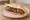 Makdous (مكدوس): an illustration of eggplant, walnuts, pepper, garlic and more on pita.