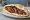 Makdous Sandwich (ساندويش مكدوس): an illustration of eggplant, walnuts, pepper, garlic and more on pita.