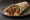 Manisa Kebabı Dürüm: an illustration of beef, tomato, onion, parsley and more on pita.