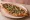 Mantarlı Pide: an illustration of mushroom, onion, butter and parsley on pita.