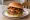 Maple Bacon Burger: an illustration of beef, bacon, cheddar cheese, maple syrup and more on burger bun.