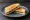 Marmite Sandwich: an illustration of butter and marmite on white bread.