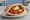 Matbucha b'Pita (מטבוחה בפיתה): an illustration of tomato, pepper, garlic and olive oil on pita.