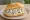 Matjes Hausfrauenart: an illustration of herring, sour cream, apple, onion and more on kaiser roll.