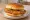 McDonald's McCrispy: an illustration of chicken, pickle and butter on burger bun.