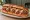 Meatball Grinder: an illustration of beef, pork, mozzarella and marinara on hoagie roll.