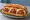 Meatball Parm Hero: an illustration of beef, pork, mozzarella and marinara on hoagie roll.