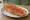 Media Tostada: an illustration of olive oil and tomato on baguette.