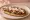 Memela: an illustration of beans, salsa and queso fresco.