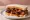 Memphis Rib Tips Sandwich: an illustration of pork and bbq sauce on white bread.