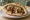 Meorav with Hummus (מעורב עם חומוס): an illustration of chicken, hummus, onion, cumin and more on pita.