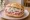 Mett Brötchen mit Zwiebeln: an illustration of pork, onion and pepper on kaiser roll.