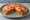 Mexican Pizza: an illustration of beef, beans, tomato and cheese on tortilla.