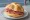Michetta con Salame Milano: an illustration of salami and garlic.