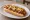 Michigan Hot Dog: an illustration of hot dog, onion and mustard on hot dog bun.