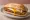 Milanesa con Huevo: an illustration of beef and egg on baguette.