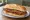 Milanesa de Carne: an illustration of beef and egg on baguette.
