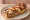 Mini Zapiekanka: an illustration of mushroom, cheese and ketchup on baguette.