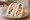 Mixed Fruit Sandwich: an illustration of strawberry, kiwi, orange and whipped cream on shokupan.
