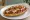 Mollete con Chorizo: an illustration of chorizo, beans and cheese on telera roll.