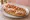 Mollete con Jamón: an illustration of ham, beans and cheese on telera roll.