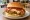 Mom's Touch — Arrabbiata Burger: an illustration of chicken and mozzarella on burger bun.