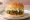 Mom's Touch — Bulgogi Burger: an illustration of beef, bbq sauce and lettuce on burger bun.