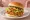Mom's Touch — Jalapeño Burger: an illustration of chicken, jalapeño, lettuce, onion and more on burger bun.