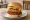 Mom's Touch — Shrimp Bulgogi Burger: an illustration of beef, shrimp, bbq sauce and lettuce on burger bun.